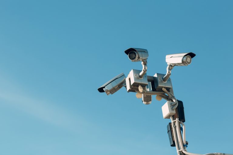 A high-definition surveillance camera overlooking a commercial parking lot.